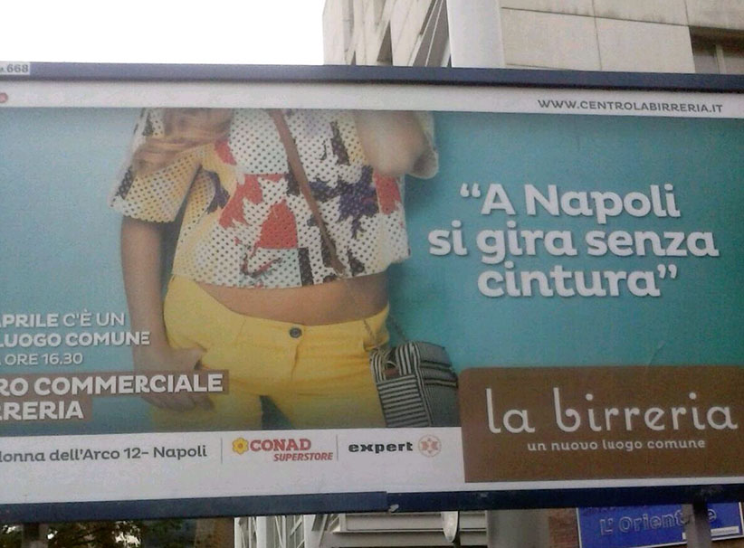 ‘A Napoli si gira senza cintura’ polemiche contro il manifesto del nuovo centro commerciale